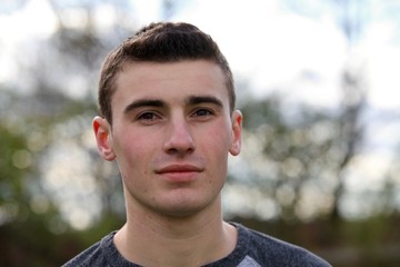 Portrait head shot of a teenage boy posing 