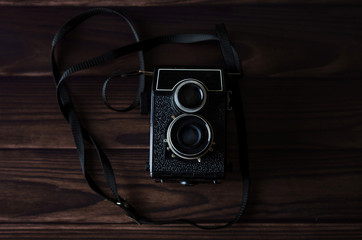 Fototapeta na wymiar Old vintage camera on a wooden table.