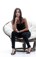 Fototapeta na wymiar Young business woman sitting in a wide round chair.