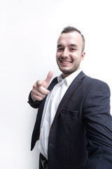 Happy successful businessman pointing on copy space