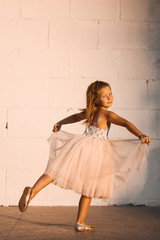 little girl beautiful smiling dancing in pink dress tutu as ballerina on sunny day happy childhood