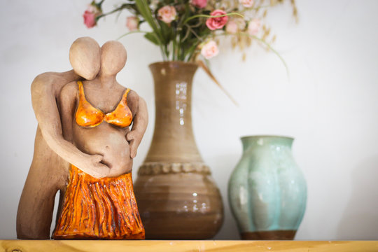 Clay sculpture of pergnant couple