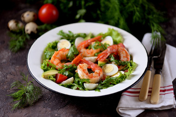 Salad from shrimp tails with lettuce, arugula, quail eggs, cherry tomatoes, avocado, olive oil and balsamic vinegar.