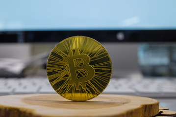 Golden bitcoin on a wooden background