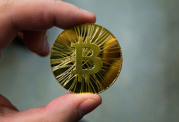 Golden bitcoin on a black background