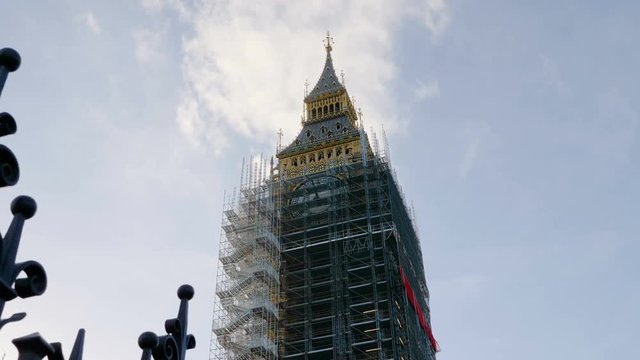 Big Ben (Elizabeth Tower) restoration surrounded by scaffolding during conservation refurbishment. London, UK, 4k