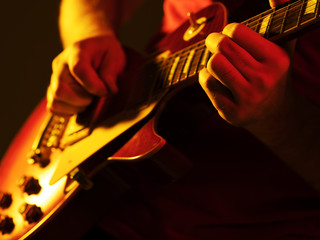 man playing guitar on a stage musical concert close-up view