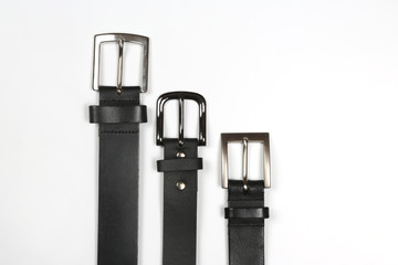 three black leather belt on white background.