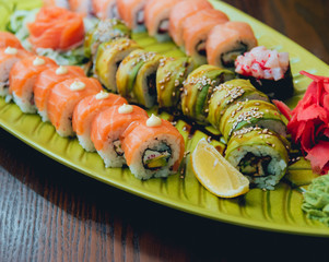 Sushi and rolls with salmon, prawn, avocado, cream cheese. Sushi menu. Japanese food.