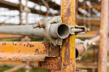 Scaffolding poles held together with a clamp