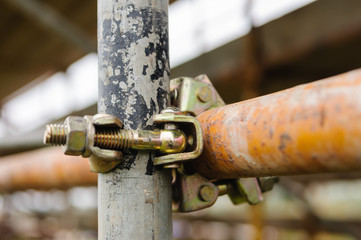 Scaffolding poles held together with a clamp