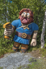 Wooden statue in norwegian landscape