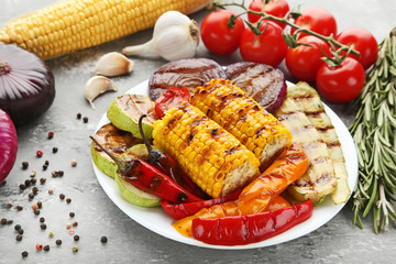 Grilled vegetable in plate with rosemary, and garlic on wooden table
