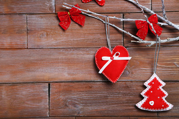 Christmas decoration hanging on rope on wooden background