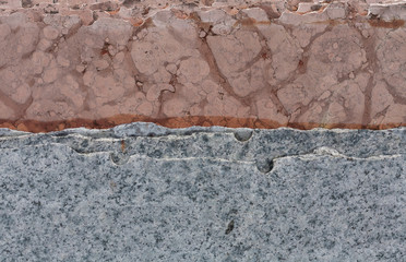slabs of  pink and gray granite stacked vertically