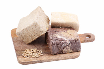 Tasty halva on cutting board isolated on white
