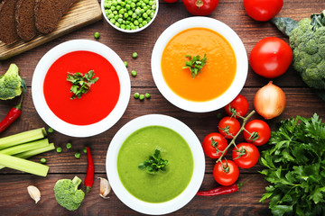 Vegetable cream soup with parsley on wooden table