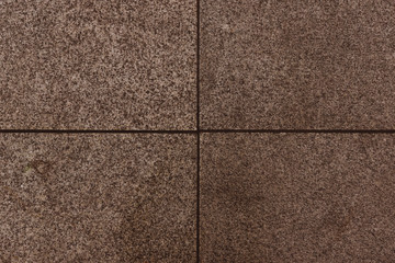 Four polished granite tiles. Brown stone polished background