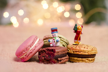 Gorgeous Christmas cookies, bokeh background, little wooden figurines of snowman on macaroons
