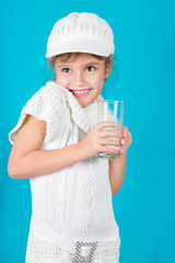 Beautiful little girl with glass of milk
