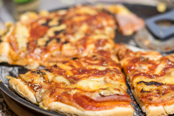 Fresh baked and sliced pizza with mushrooms ketchup ham and cheese
