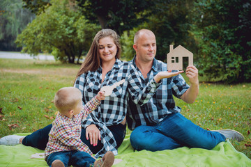 Young family with advertising signs in the park.