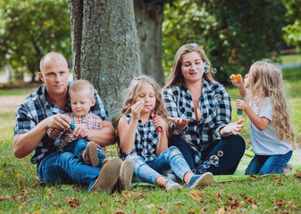 Young family with cheerful children in the park