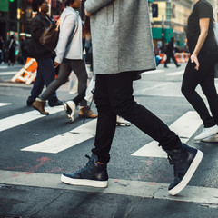 Man walking on crosswalk in the city street crowd at winter time