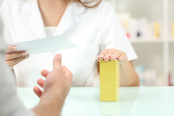 Pharmacist preparing medicine reading recipe