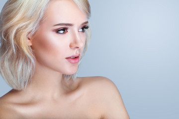 Fototapeta premium Beauty smiling model with natural make up and long eyelashes. Youth and skin care concept. Spa and wellness. Make up, short hair and lashes. Close up, selective focus.
