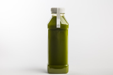 Fresh celery spinach juice in plastic bottle. White background. Healthy nutrition. Detox juice diet. Big size