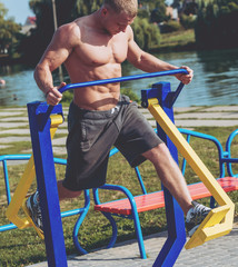 Young athlete training and doing workout outdoors in city.