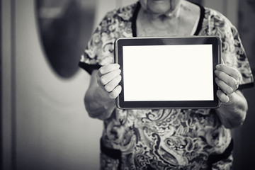 elder woman holding tablet