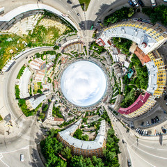 Aerial city view with crossroads and roads, houses, buildings, parks and parking lots, bridges. Helicopter drone shot. Wide Panoramic image.