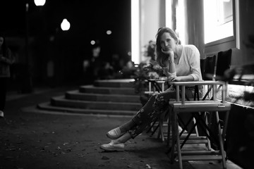 Girl sitting in a chair at night