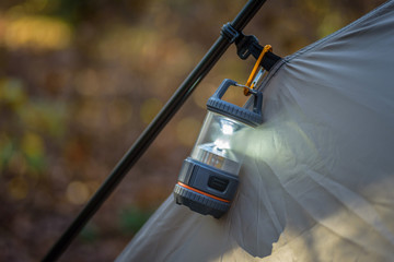 closeup of tent and lantern in fall