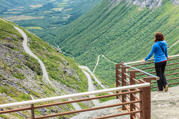 Fototapeta na wymiar Tourist woman on Trollstigen viewpoint in Norway