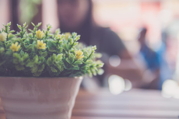 dry flower in steel can decoration in coffee shop on wood table