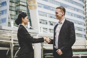 Business people shaking hands, finishing up meeting deals. Business concept.