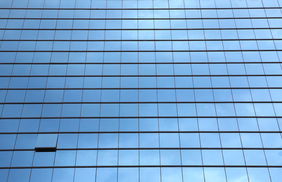 Blue sky reflected in the glass building.