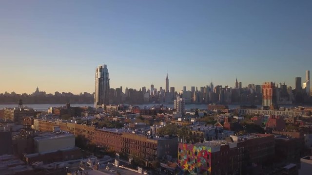 shot of Manhattan skyline flying backward revealing Greenpoint Brooklyn church
