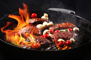 Delicious cooked meat with vegetables on grill