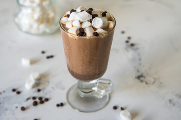 Hot chocolate or cocoa in a glass mug with marshmallows