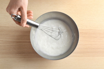 Woman making pudding on kitchen table