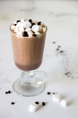 Hot chocolate or cocoa in a glass mug with marshmallows