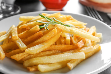 Plate with yummy french fries, closeup