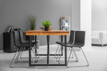 Modern room interior with wooden table