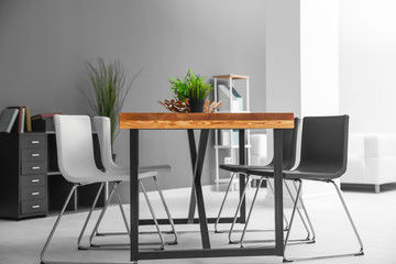Modern room interior with wooden table