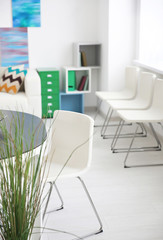 White chair near table indoors