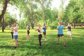 Group of young people training in park